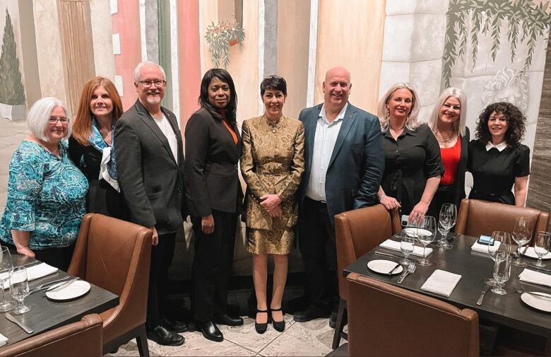 People pose in a restaurant.