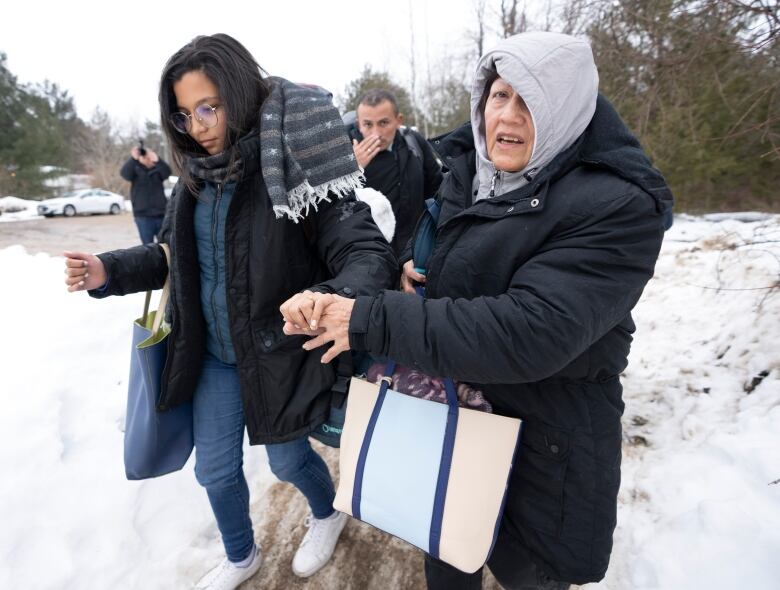 A family of asylum seekers from Colombia crosses the border at Roxham Road into Canada on Thursday, February 9, 2023  in Champlain, New York.