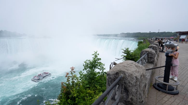 A Niagara tour boat to the falls with less-than-capacity onboard approaches the Horseshoe Falls in Niagara Falls, Ontario