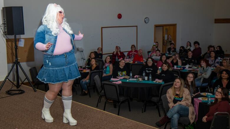 A drag queen performs on stage.