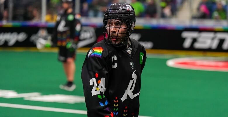 Lacrosse player on the field in special edition jersey with rainbow motif.