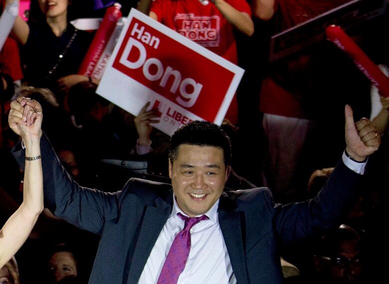 Candidate Han Dong celebrates with supporters while taking part in a rally in Toronto on Thursday, May 22, 2014.