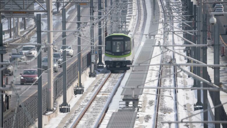 Head-on view of new green-and-white electric train.