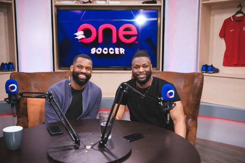 Jordan Wilson and Jelani Smith are both sitting at a desk insi a studio.