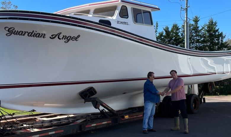 two people shaking hands and a boat