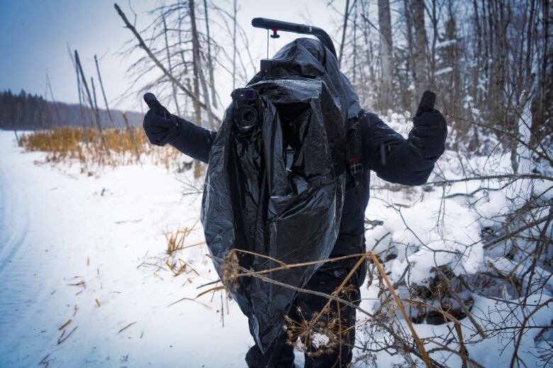 Filmmaker and explorer Felipe Gomez stays warm and dry while shooting a mini-documentary about the dog sled mushers for CBC's Creator Network.