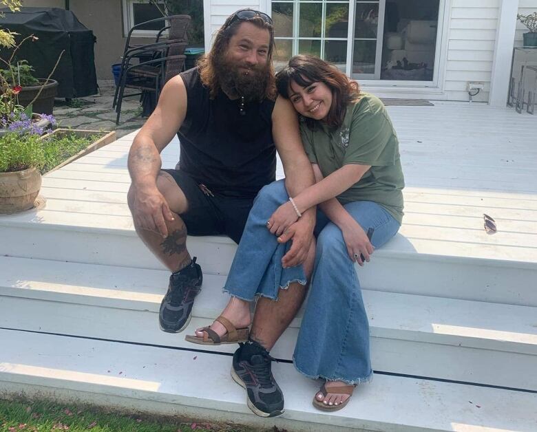 A man and woman sit together.