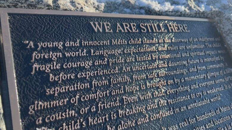 A bronze plaque describes the pain and suffering Metis and other Indigenous children went through at the le--la-Crosse boarding school.