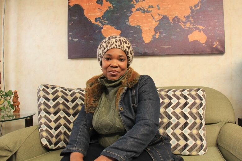 Idemudia Keinde sits on a sofa in Matthew House.