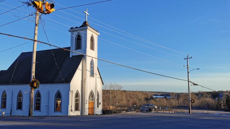 A large church stands at the side of a road.