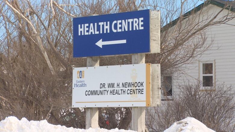 A blue sign reads 'Health Centre', with another sign below reading, 'Dr. WM. H. Newhook Community Health Centre.'