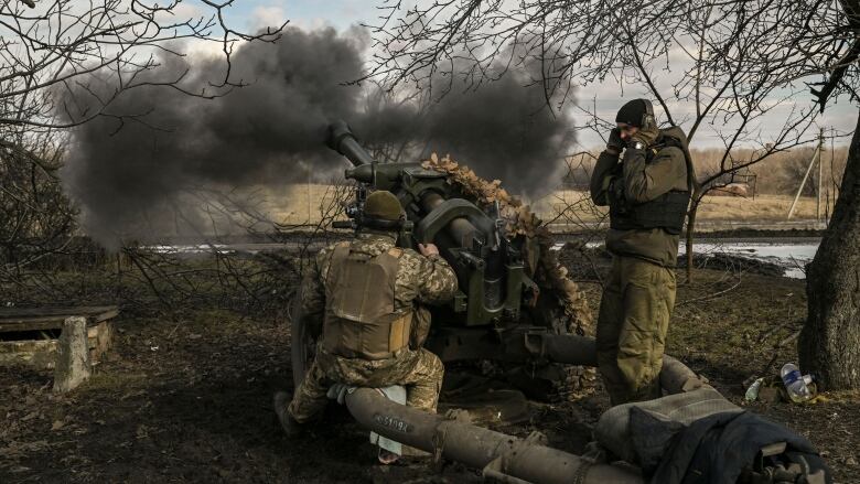 Ukrainian soldiers fire a Howitzer towards Russian positions near Bakhmut, Ukraine.