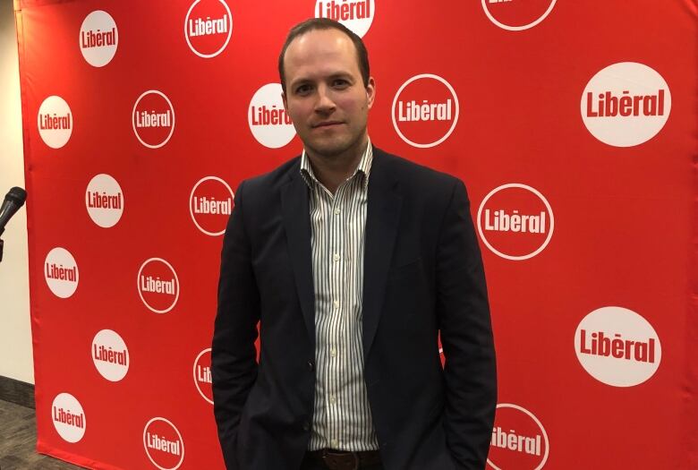 Photo of Nate Erskine-Smith against a backdrop of the Ontario Liberal Party logo. 