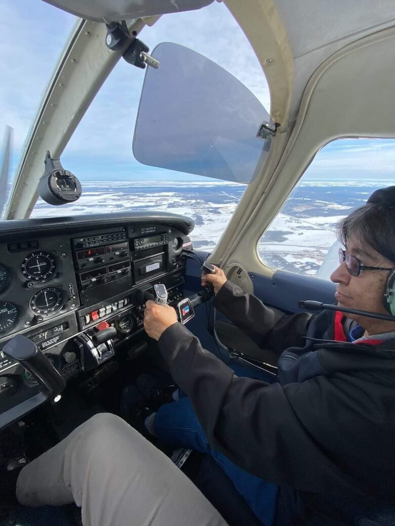 Louise Wood at the controls of the airplane.