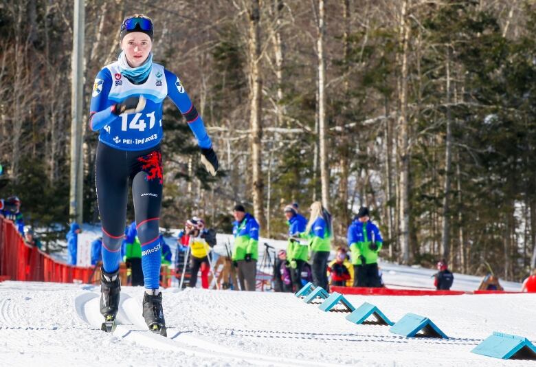 A woman is seen competing in a skiing event.