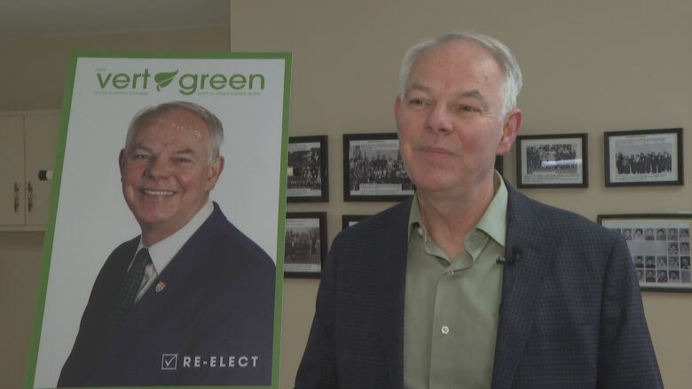 Green Leader Peter Bevan-Baker faces the camera with an election sign in the background.