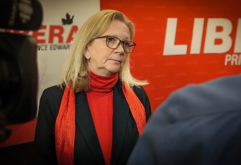 Sharon Cameron in front of campaign sign.