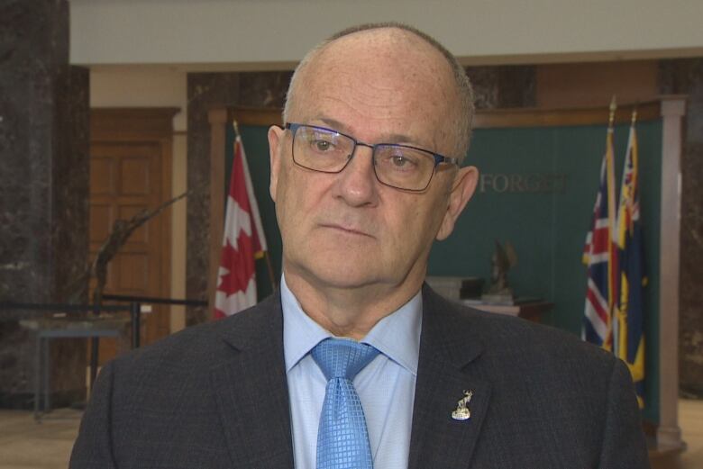 A middle-aged man speaks with a CBC reporter in the East Block of the Confederation Building in St. John's.