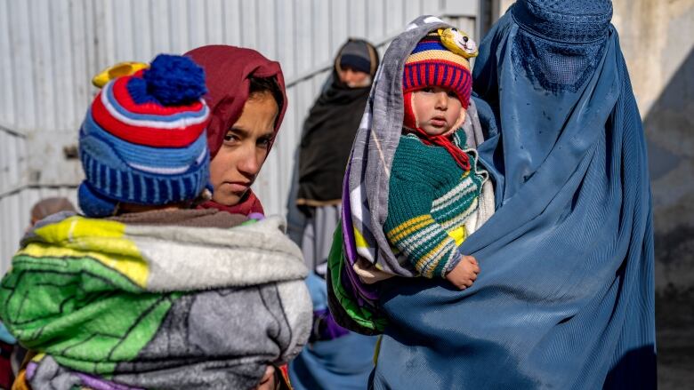 Mothers along with babies who suffer from malnutrition wait to receive help and check-up at a clinic