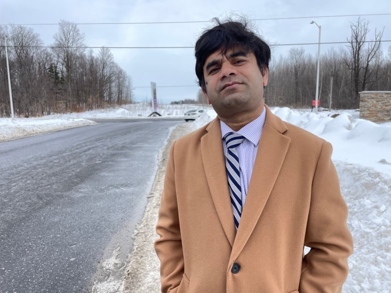 Kamal Hossain, a professor of transportation engineering at Carleton University in Ottawa, stand at the corner of Greenbank Road and Cappamore Drive in the city's south end.