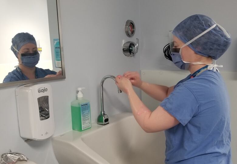 person scrubbing for surgery