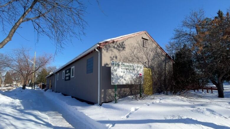 A community centre is surrounded by snow.