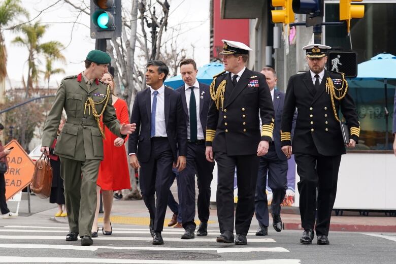 Britain's Prime Minister Rishi Sunak, left to right, Col Jaimie Norman, Admiral Sir Ben Key, First Sea Lord, and Commander Gus Carnie during Sunak's visit to San Diego, Monday March 13, 2023, ahead of his meetings with US President Joe Biden and Prime Minister of Australia Anthony Albanese as part of AUKUS. Experts are warning that Canada's omission from the military pact involving three of its closest allies is symptomatic of a larger problem in how this country is perceived by its friends. 