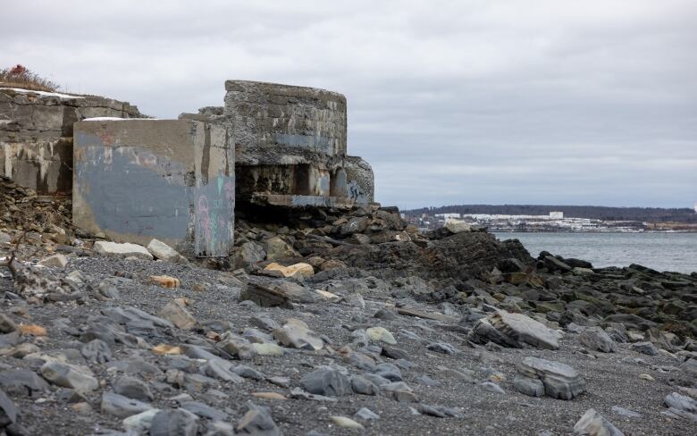 A concrete and stone structure stands at the water's edge.