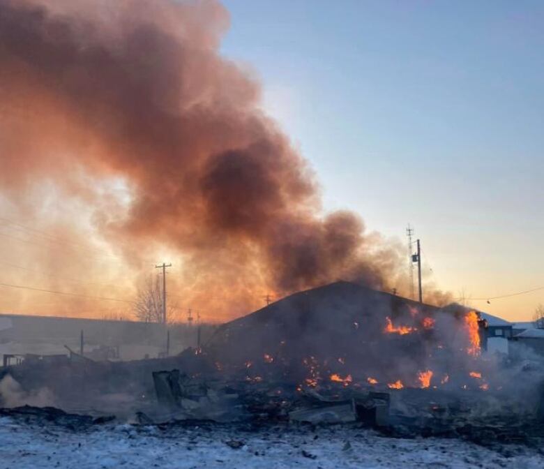 Smoke billows from a house fire.