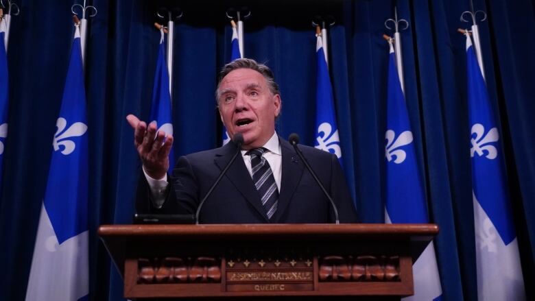 Man standing at podium speaking