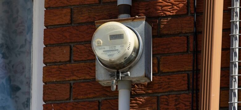 Electricity meter on the exterior wall of a house. 