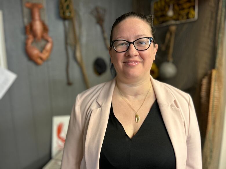 Melanie Giffin, marine biologist and program planner for the PEIFA poses infront of a lobster display at the groups head quaters in Charlottetown.