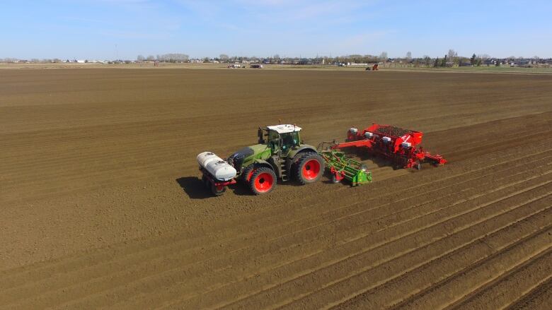 A tractor ploughs through a field.