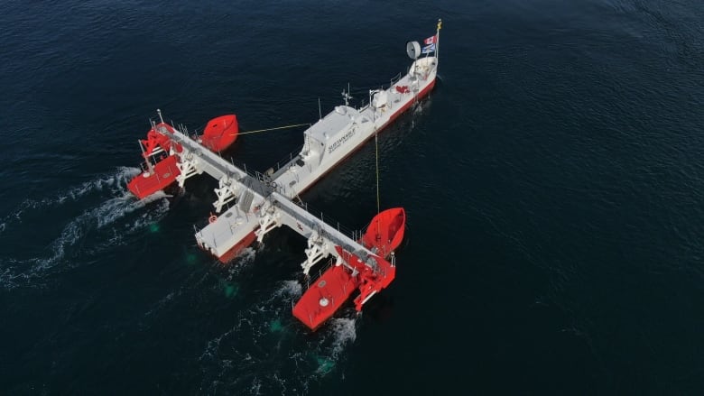 Photo of a ship with two pontoon-like structures on either side of it.