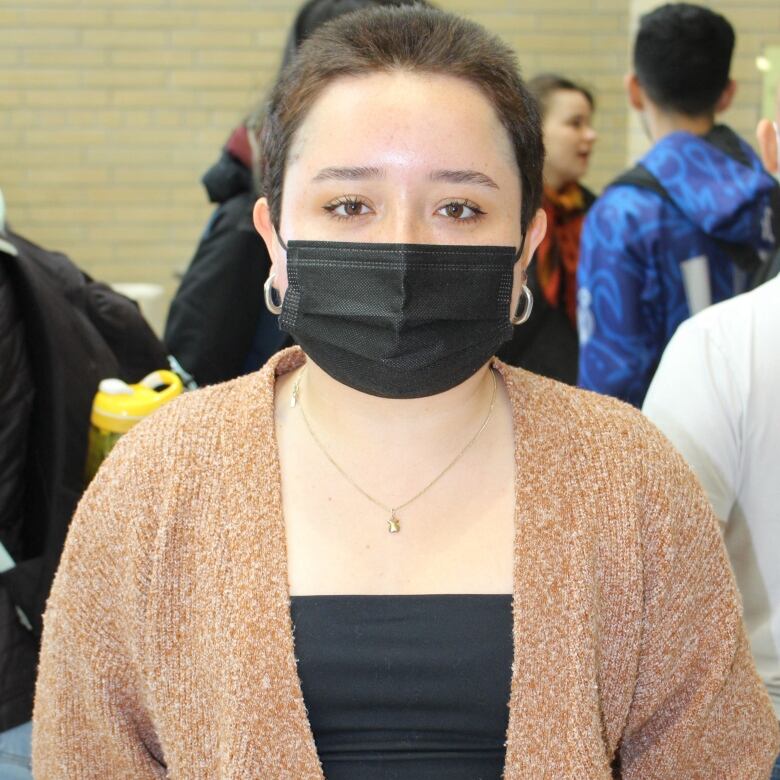 A woman wearing a mask.