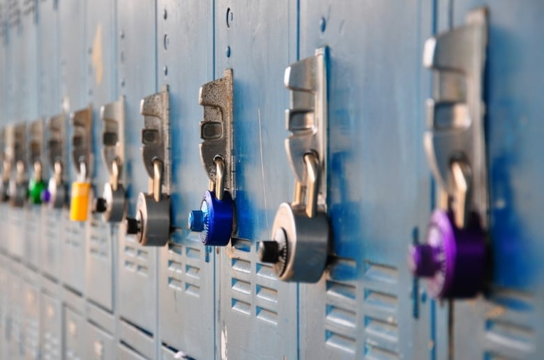 Bank of school lockers with colorful locks