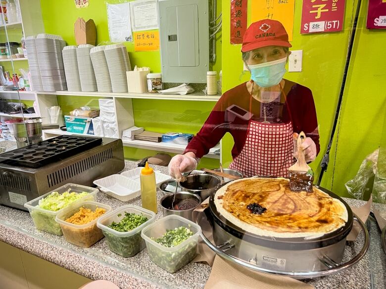 A woman making the jiang bing at YU SHAN YUAN JIANG BING.