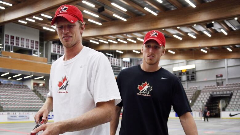 Eric Staal stands with his brother Marc Staal inside a an empty arena at the national men's team orientation camp