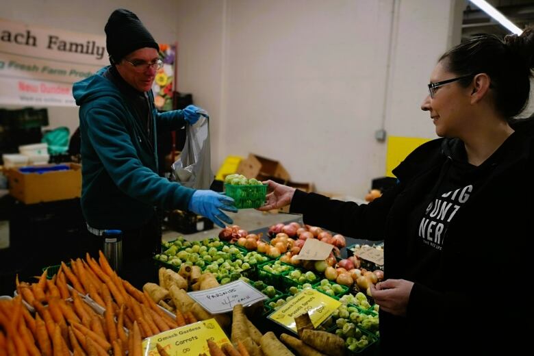 Chef Moser stops at a vegetable stand to grab winter produce