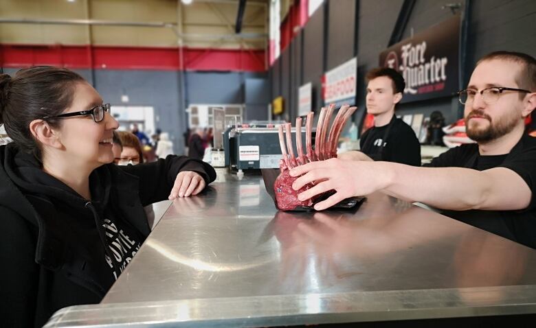 Chef Moser grabs a rack of venison from the butcher shop