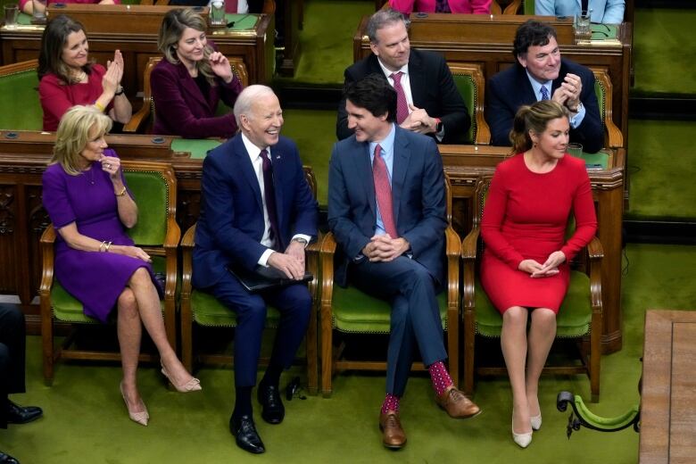 President Joe Biden, accompanied by first lady Jill Biden, talks with Prime Minister Justin Trudeau, accompanied by his wife Sophie Gregoire Trudeau.