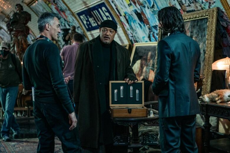 in a tunnel, behind the scenes a film director instructs two actors. 