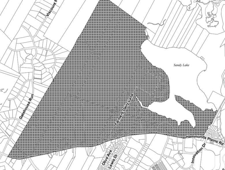 A black and white map shows the special planning area shaded in grey, west of Sandy Lake