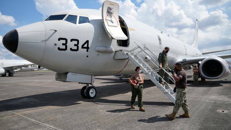 Admiral John C. Aquilino, commander of the U.S. Indo-Pacific Command (INDOPACOM), alights from a US P-8A Poseidon reconnaissance plane at Clark Air Base, Pampanga province, northern Philippines on Sunday, March 20, 2022.