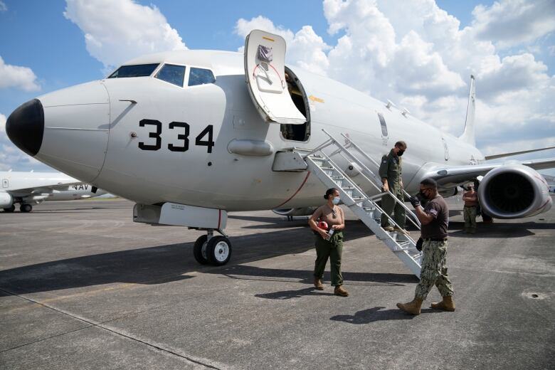 Admiral John C. Aquilino, commander of the U.S. Indo-Pacific Command (INDOPACOM), alights from a US P-8A Poseidon reconnaissance plane at Clark Air Base, Pampanga province, northern Philippines on Sunday, March 20, 2022.