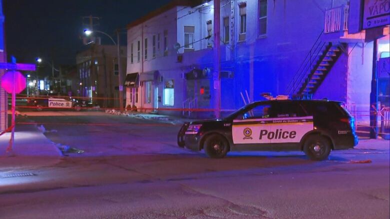 An SQ cruiser in front of a taped-off residence