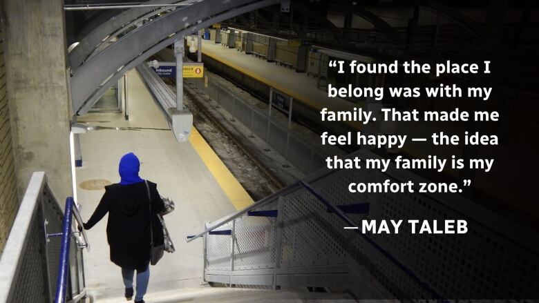 A woman wearing a hijab walks down in to the train station. 