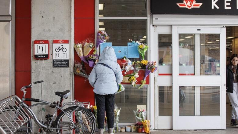 A memorial for 16-year-old Gabriel Magalhaes, who died after being stabbed at Keele subway station, is pictured in Toronto near the doors of the station. 