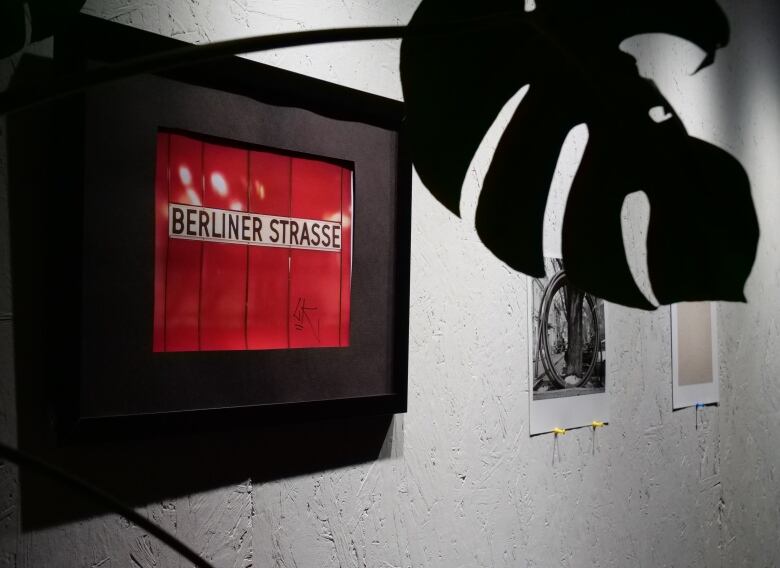 A red sign with black lettering reads: Berliner Strasse. 