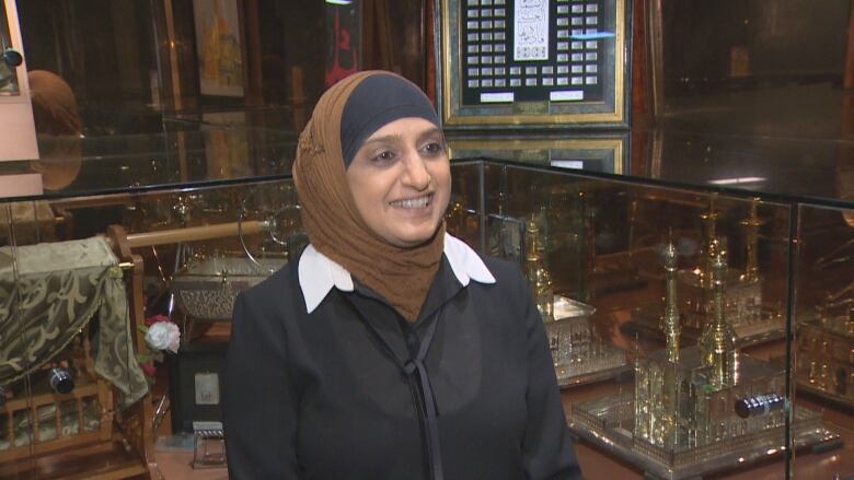 A Muslim woman pictured at the Az-Zahraa Islamic centre dressed in black and a black and brown hijab explaining the significance of charity during Ramadan.